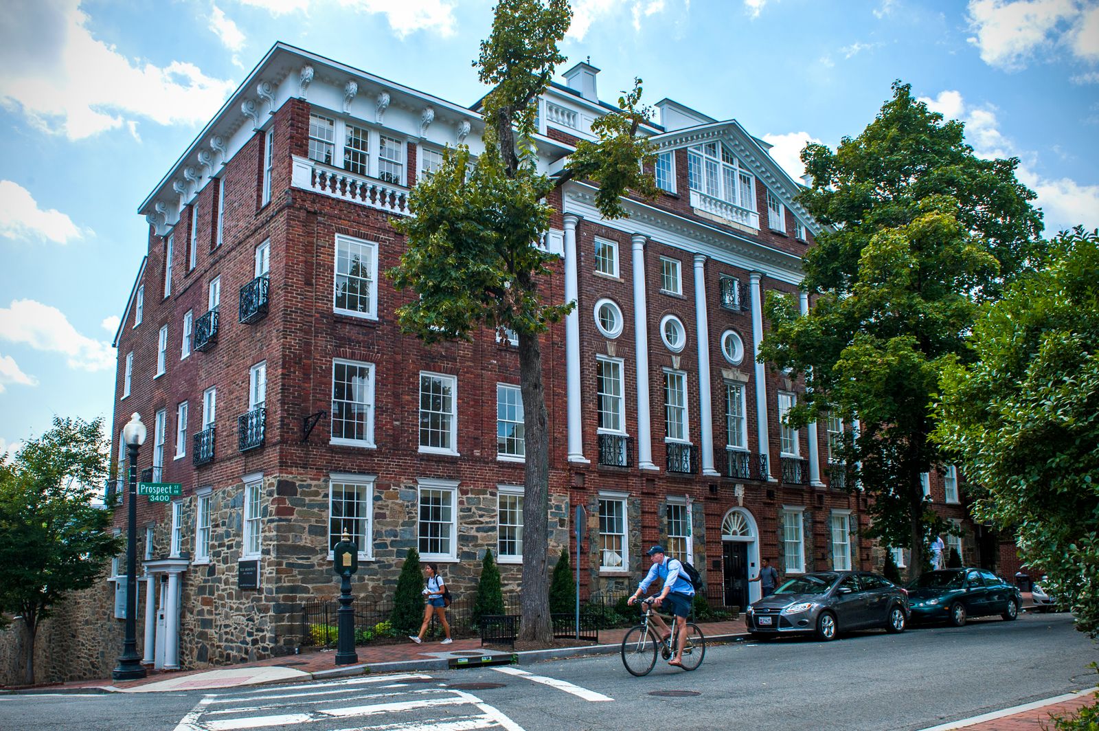 Image may contain City Urban Neighborhood Adult Person Architecture Building Machine Wheel Car and Transportation