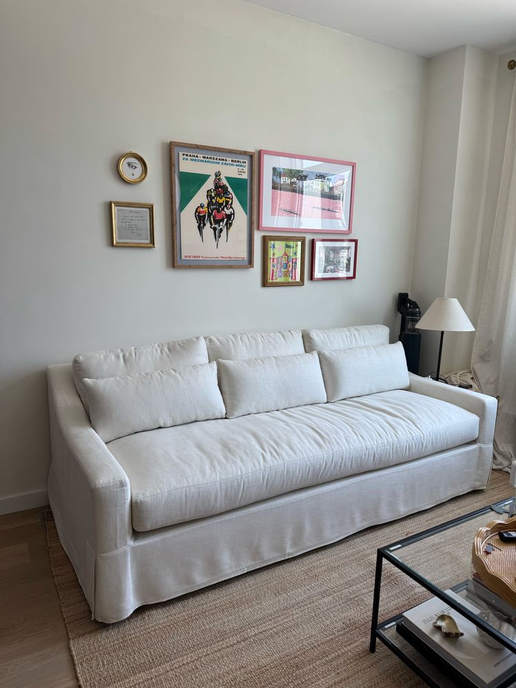 Image may contain: Couch, Furniture, Home Decor, Lamp, Cushion, Art, Painting, Rug, Accessories, Bag, Handbag, and Pillow